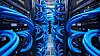 Close-up of blue network cables connected to switches in a server data center aisle